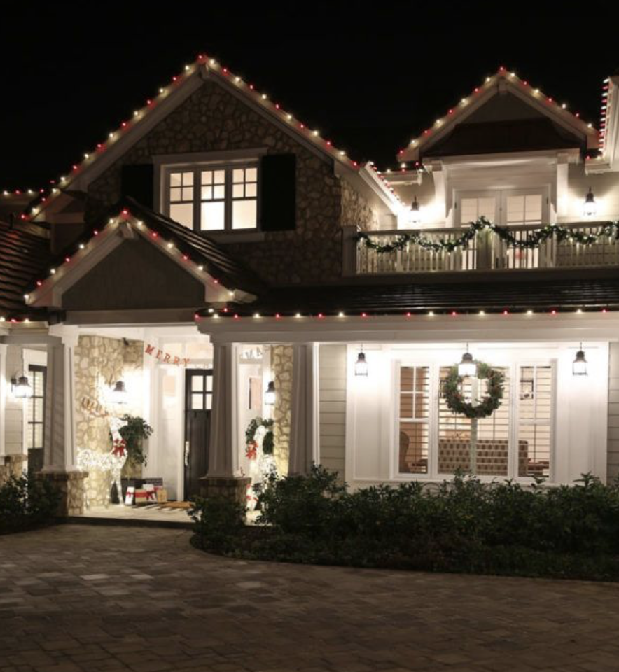 Modern farmhouse with multicolored lights and wreaths