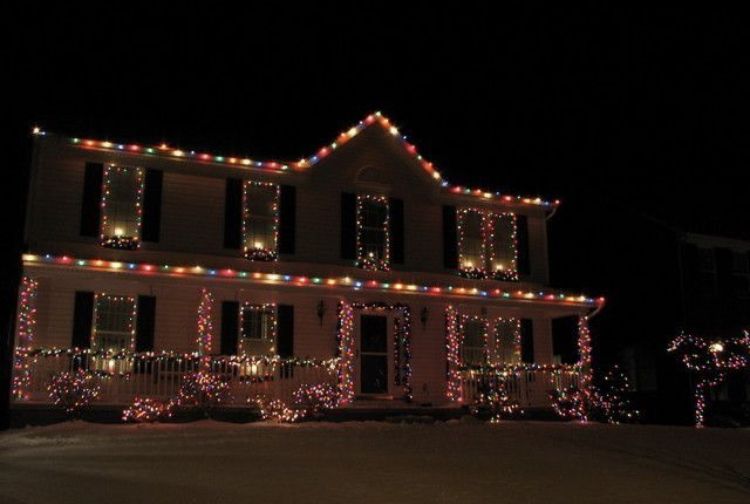 Two-story house with multicolored holiday lights