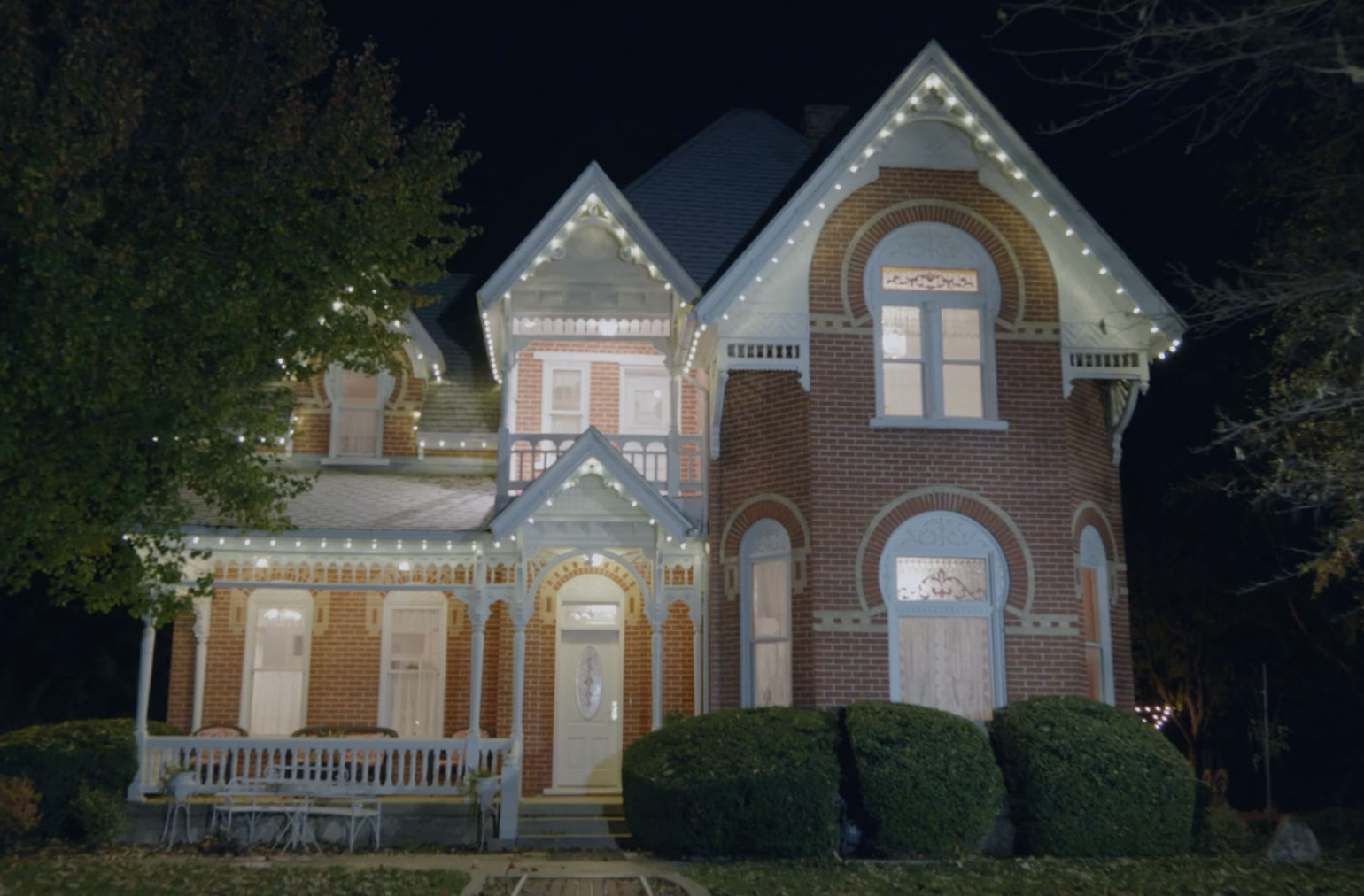 Victorian brick home with architectural lighting